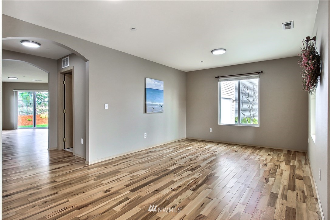 3141 Walker Road DuPont, WA 98327 - Photo 8 of 18 a view of empty room with wooden floor and fan