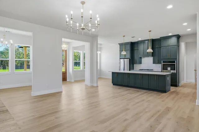 a view of kitchen with sink and refrigerator