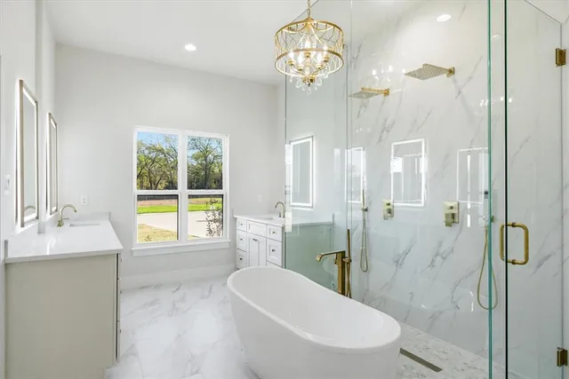 a spacious bathroom with a granite countertop sink a toilet and shower