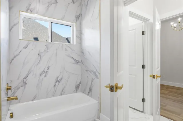 a bathroom with a bathtub and shower