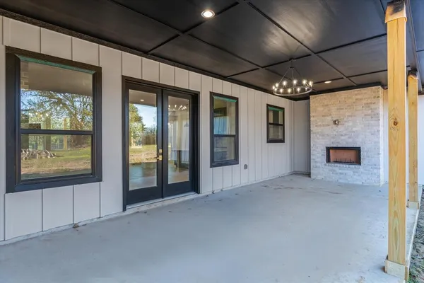 a view of an empty room with a fireplace and a window