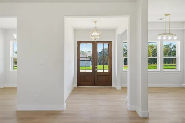 a view of entryway with wooden floor and windows