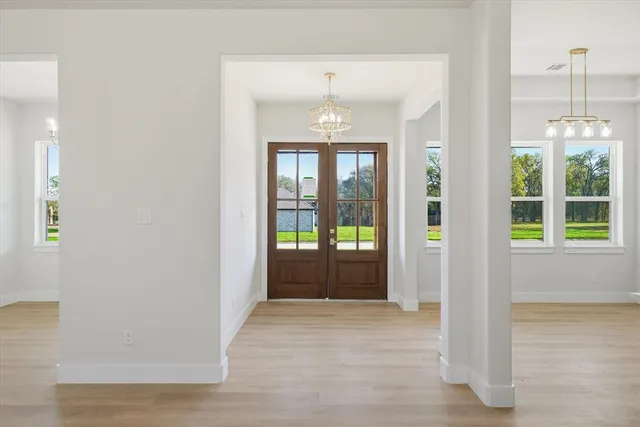 a view of entryway with wooden floor and windows