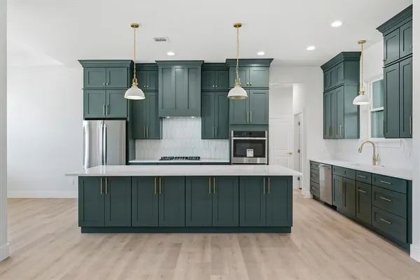 a spacious bathroom with a sink and a mirror