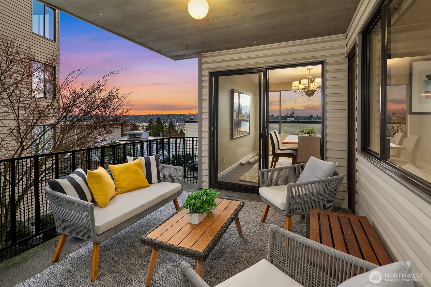 3608 26th Place West, Unit 201 Seattle, WA 98199 - Photo 12 of 33 a view of a patio with couches and a potted plant on a table