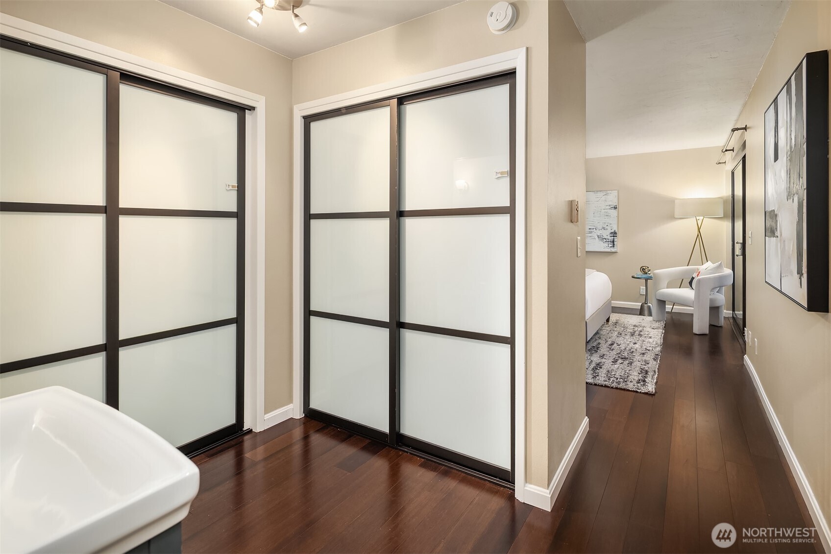 3608 26th Place West, Unit 201 Seattle, WA 98199 - Photo 13 of 33 a view of a hallway with wooden floor and furniture