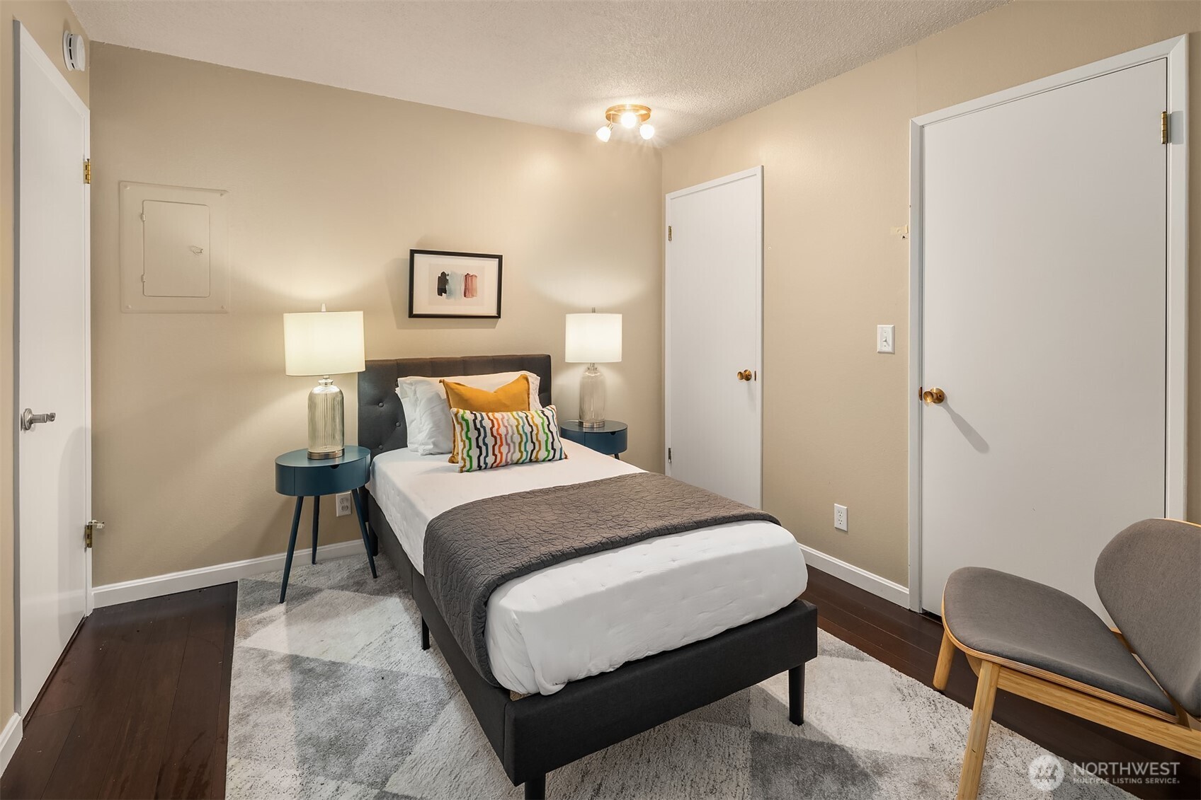 3608 26th Place West, Unit 201 Seattle, WA 98199 - Photo 16 of 33 a bedroom with a bed and chair