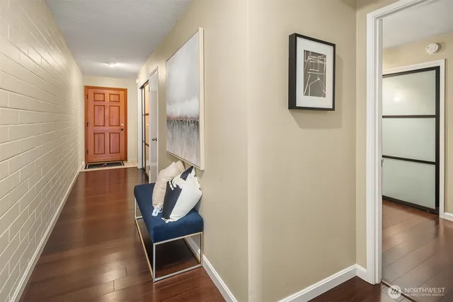 a hallway with chairs and wooden floor