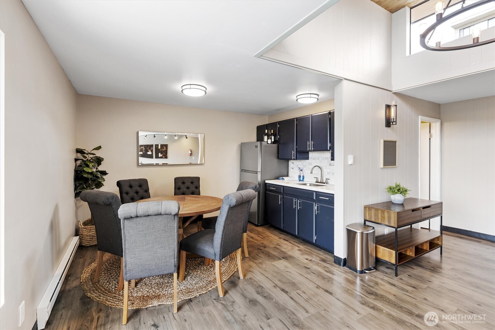3608 26th Place West, Unit 201 Seattle, WA 98199 - Photo 23 of 33 a view of a dining room with furniture and wooden floor
