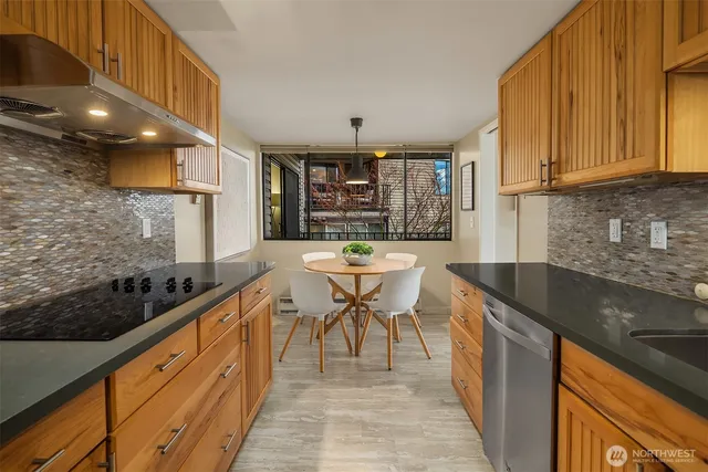 a kitchen with granite countertop a sink stove and cabinets