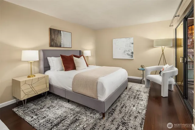 a bedroom with a bed a mirror and lamp