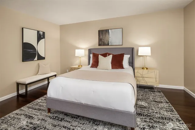 a bedroom with a bed and a lamp on table