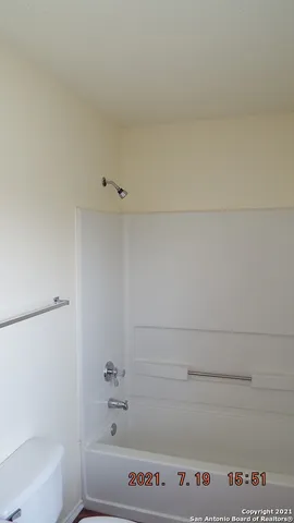 a bathroom with a bathtub and a toilet