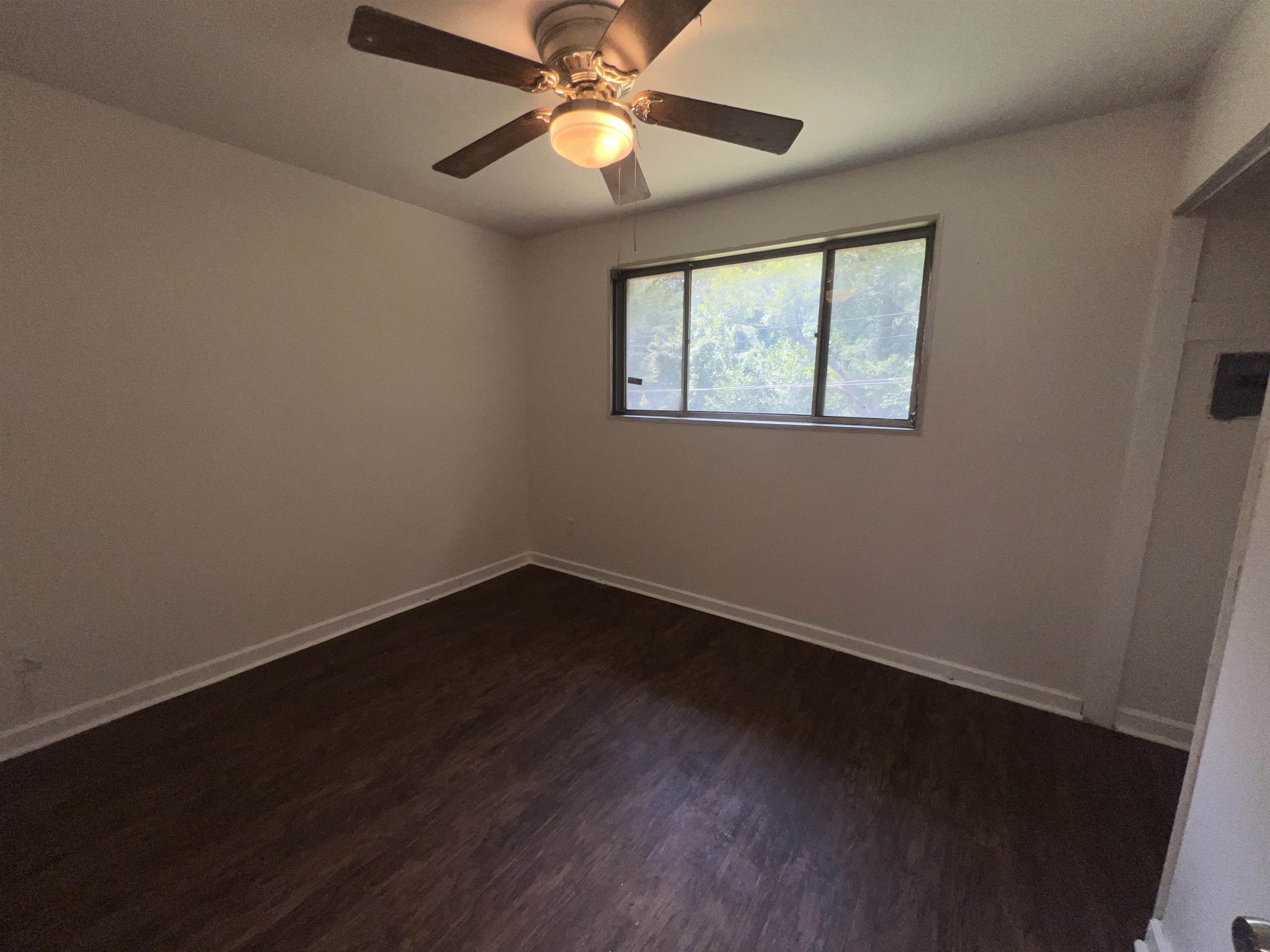 2235 Charjean Road Memphis, TN 38114 - Photo 10 of 15 Unfurnished bedroom featuring dark wood-style flooring and ceiling fan