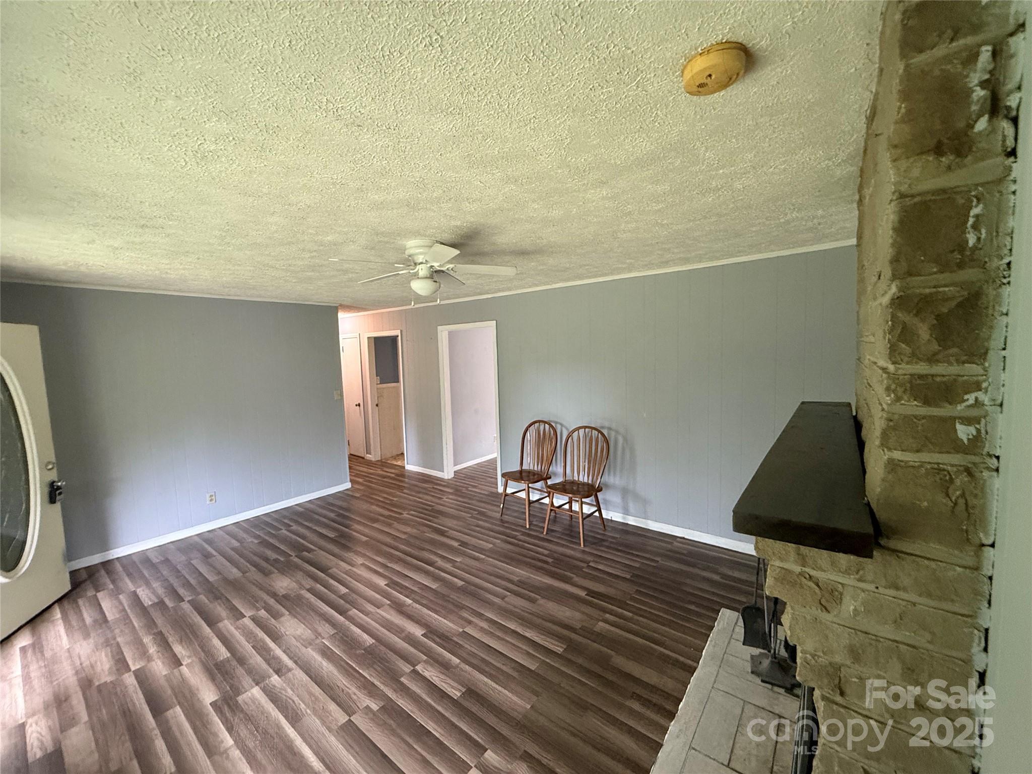 183 Maple Road Spruce Pine, NC 28777 - Photo 15 of 30 a bedroom with a bed a mirror and lamp on desk