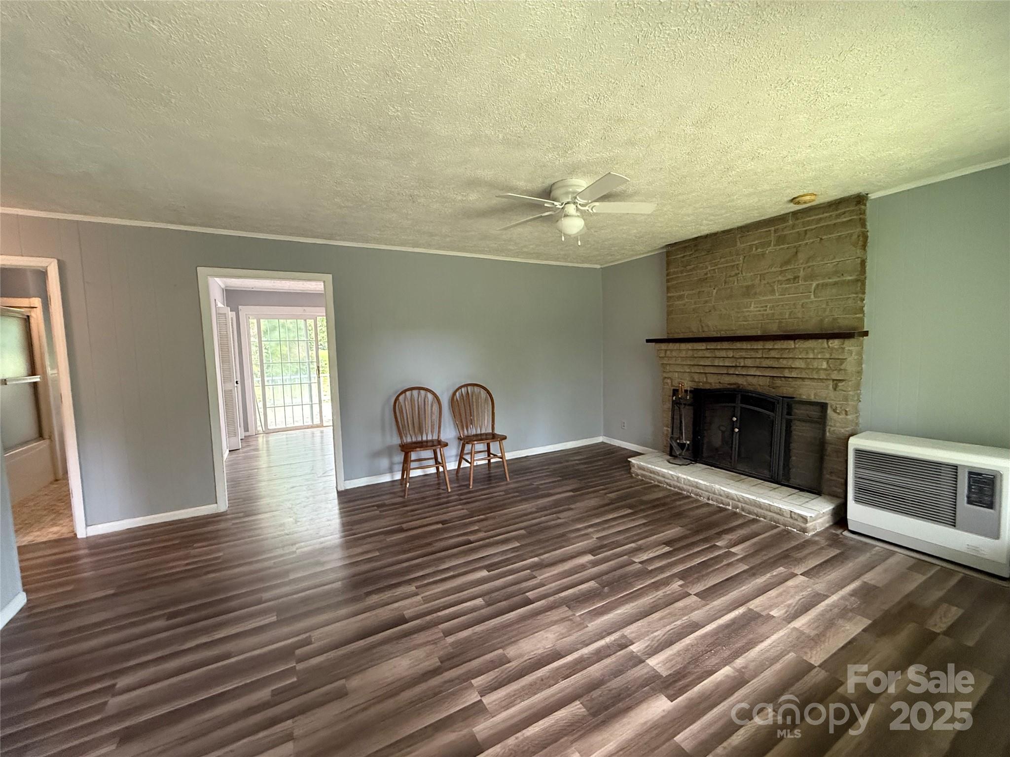 183 Maple Road Spruce Pine, NC 28777 - Photo 16 of 30 a living room with furniture and a fireplace