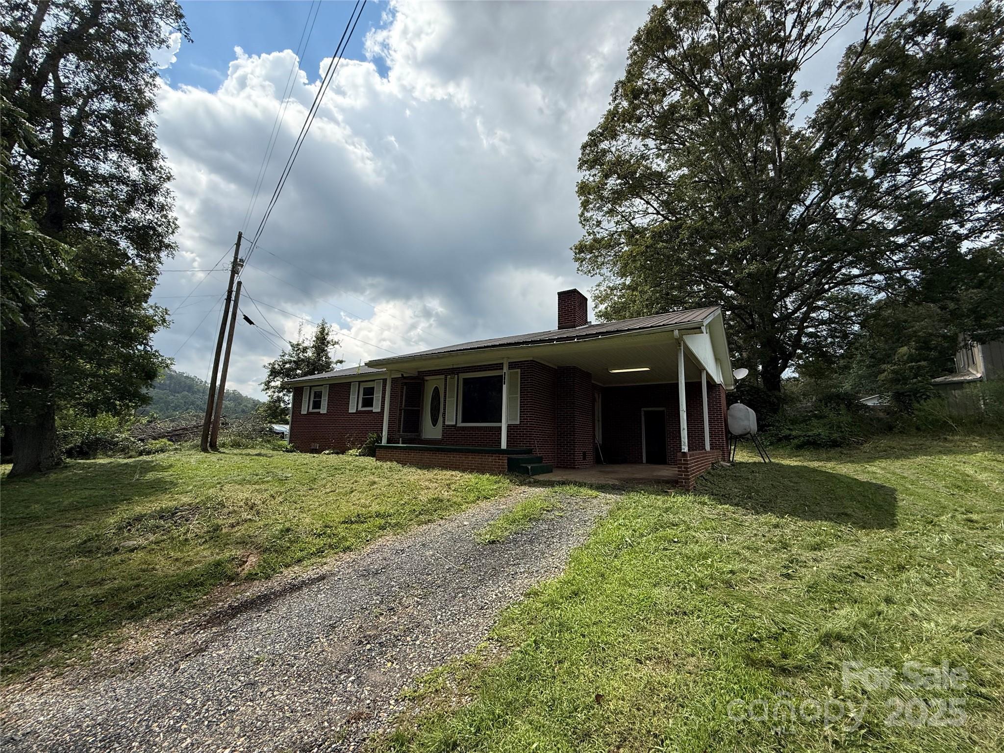 183 Maple Road Spruce Pine, NC 28777 - Photo 2 of 30 a view of a yard in front of a house with large trees