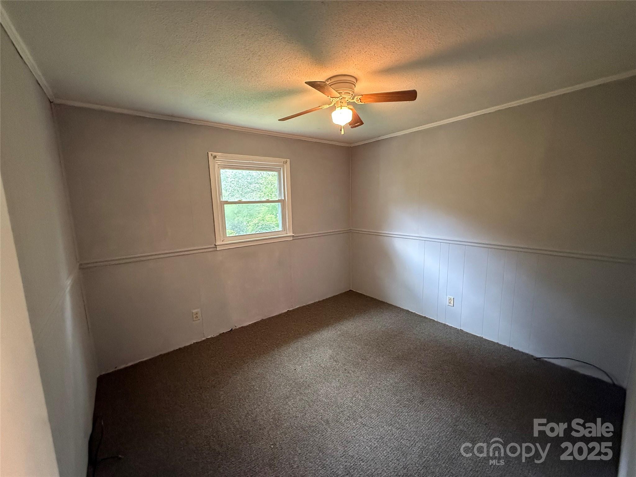 183 Maple Road Spruce Pine, NC 28777 - Photo 22 of 30 an empty room with windows and fan