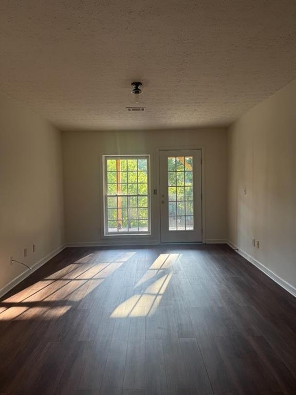 3091 Colonial Way, Unit D4 Atlanta, GA 30341 - Photo 9 of 12 an empty room with wooden floor and windows