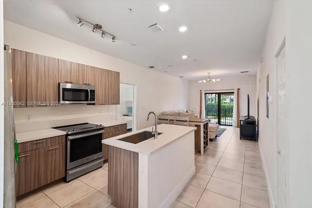 a kitchen with a sink stainless steel appliances and cabinets