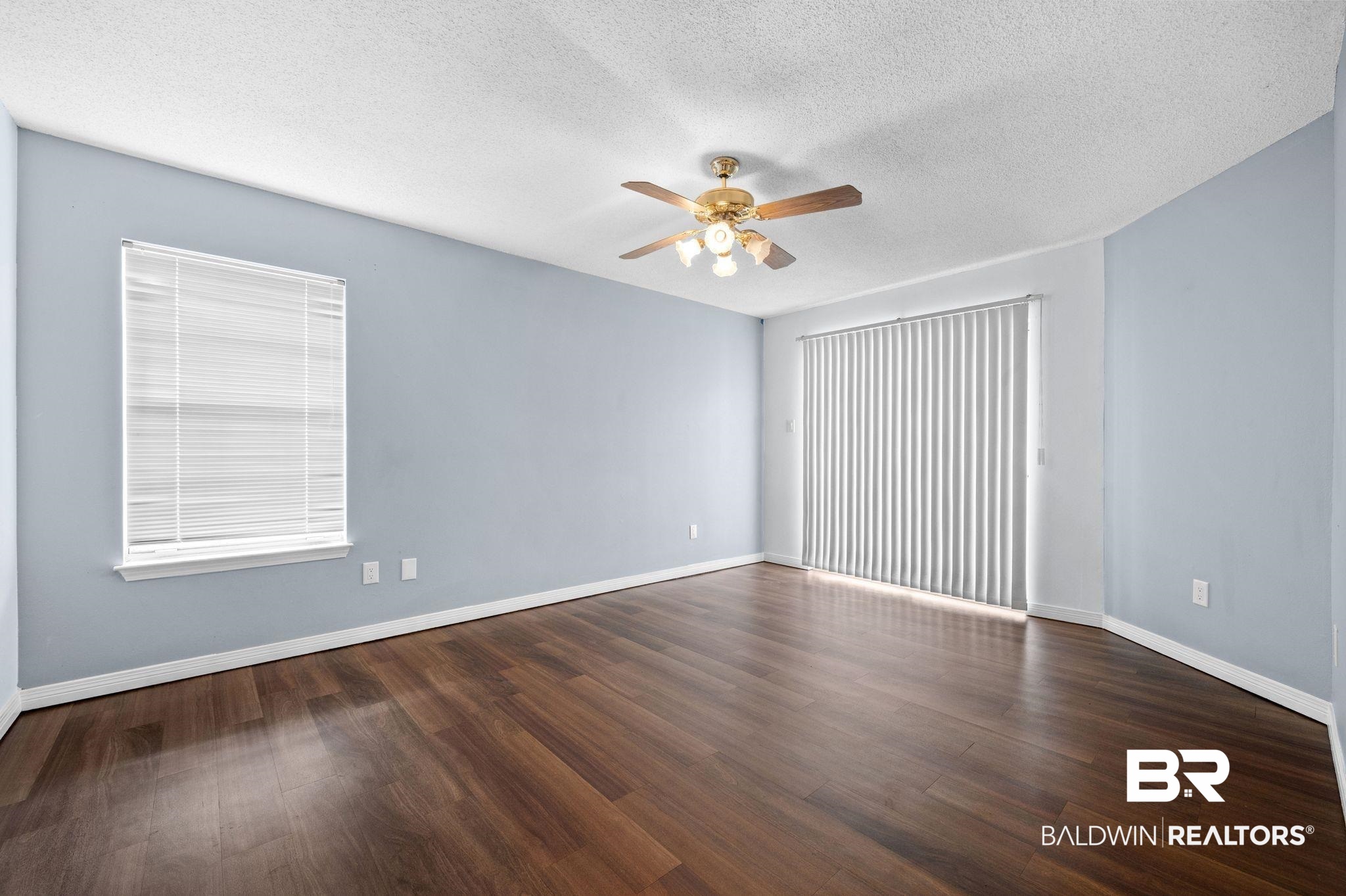 3716 Pepper Ridge Drive Mobile, AL 36693 - Photo 7 of 20 Spare room featuring ceiling fan, a textured ceiling, and dark hardwood / wood-style floors