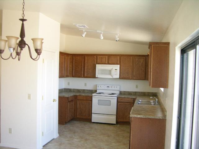 272 Paseo Mascota Rio Rico, AZ 85648 - Photo 2 of 5 a kitchen with a sink a stove and cabinets
