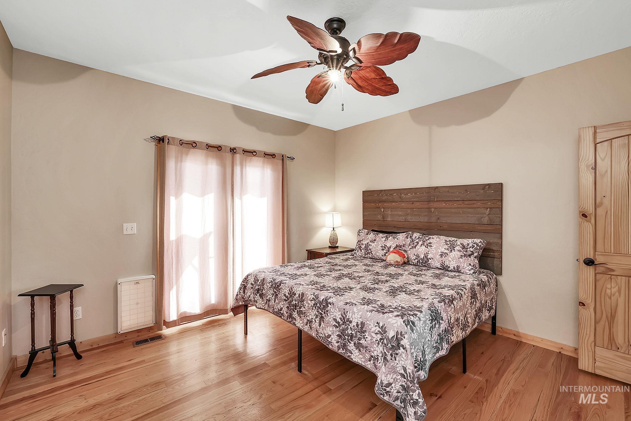 12954 Upland Road Donnelly, ID 83615 - Photo 15 of 41 Bedroom featuring ceiling fan and light wood-type flooring