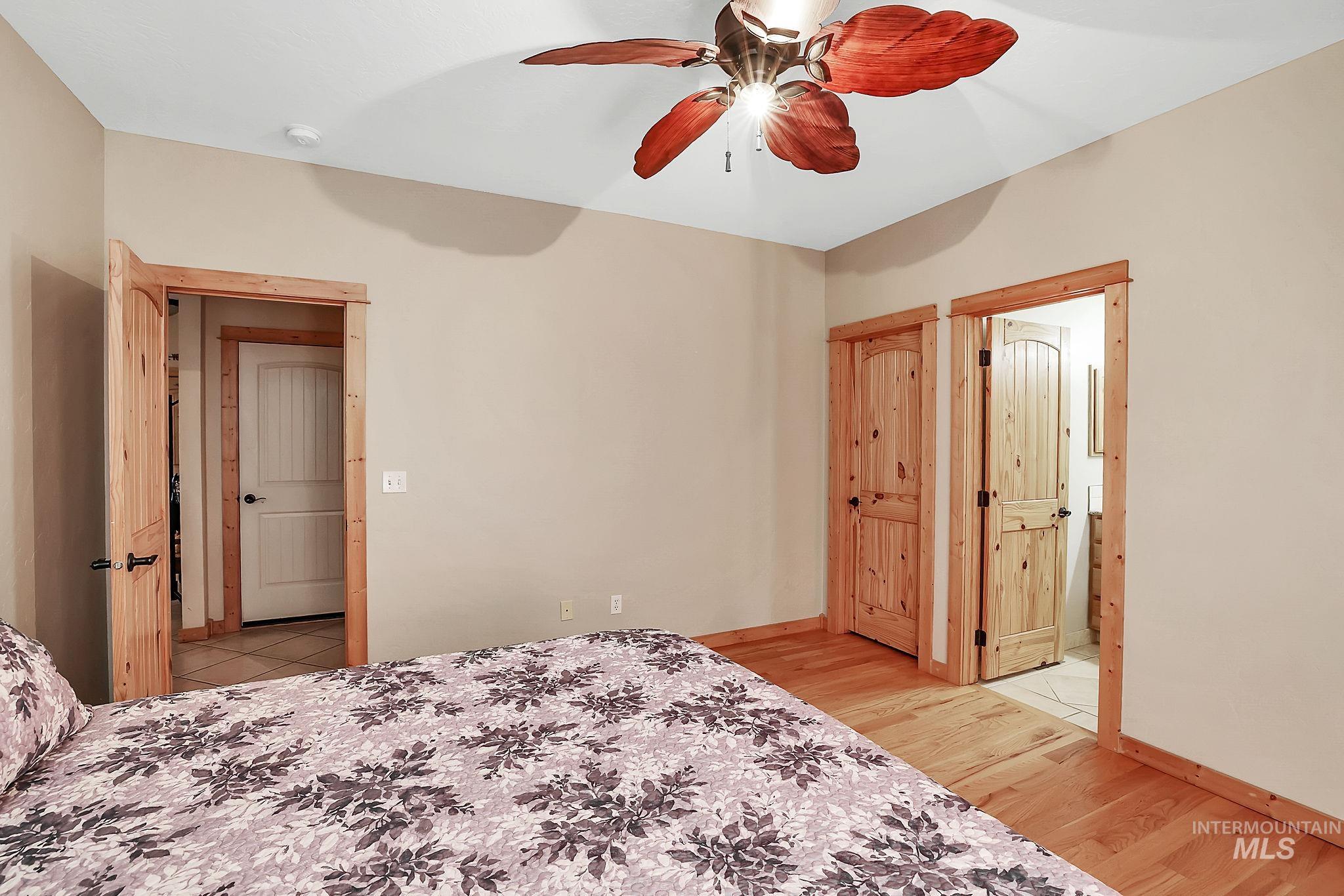 12954 Upland Road Donnelly, ID 83615 - Photo 17 of 41 Bedroom with light wood-style flooring and ceiling fan