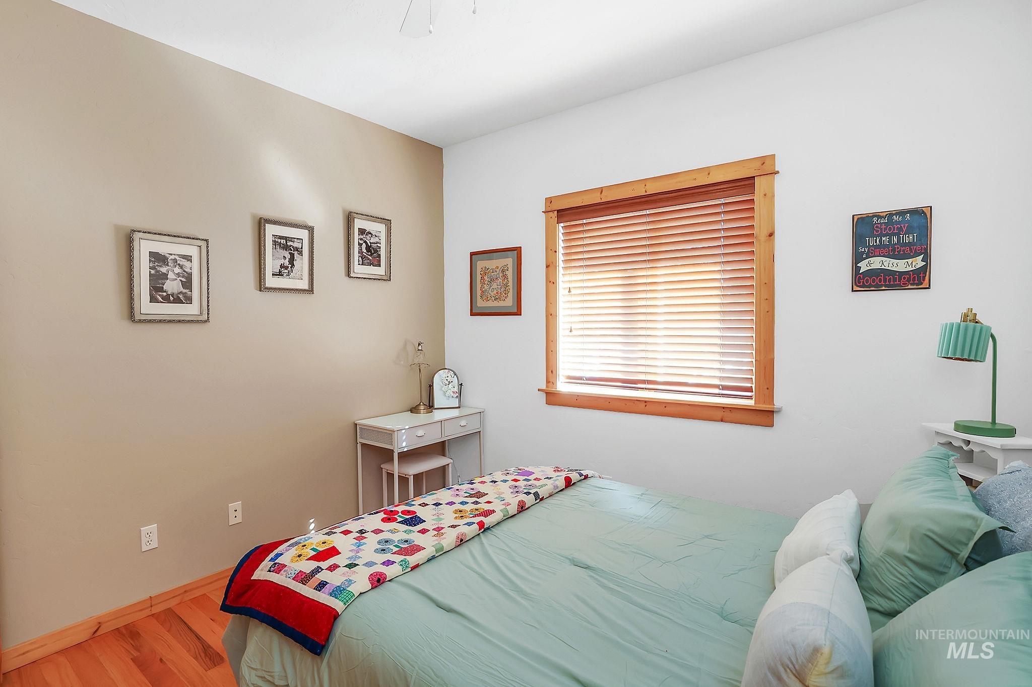 12954 Upland Road Donnelly, ID 83615 - Photo 21 of 41 Bedroom with light wood-type flooring and a ceiling fan