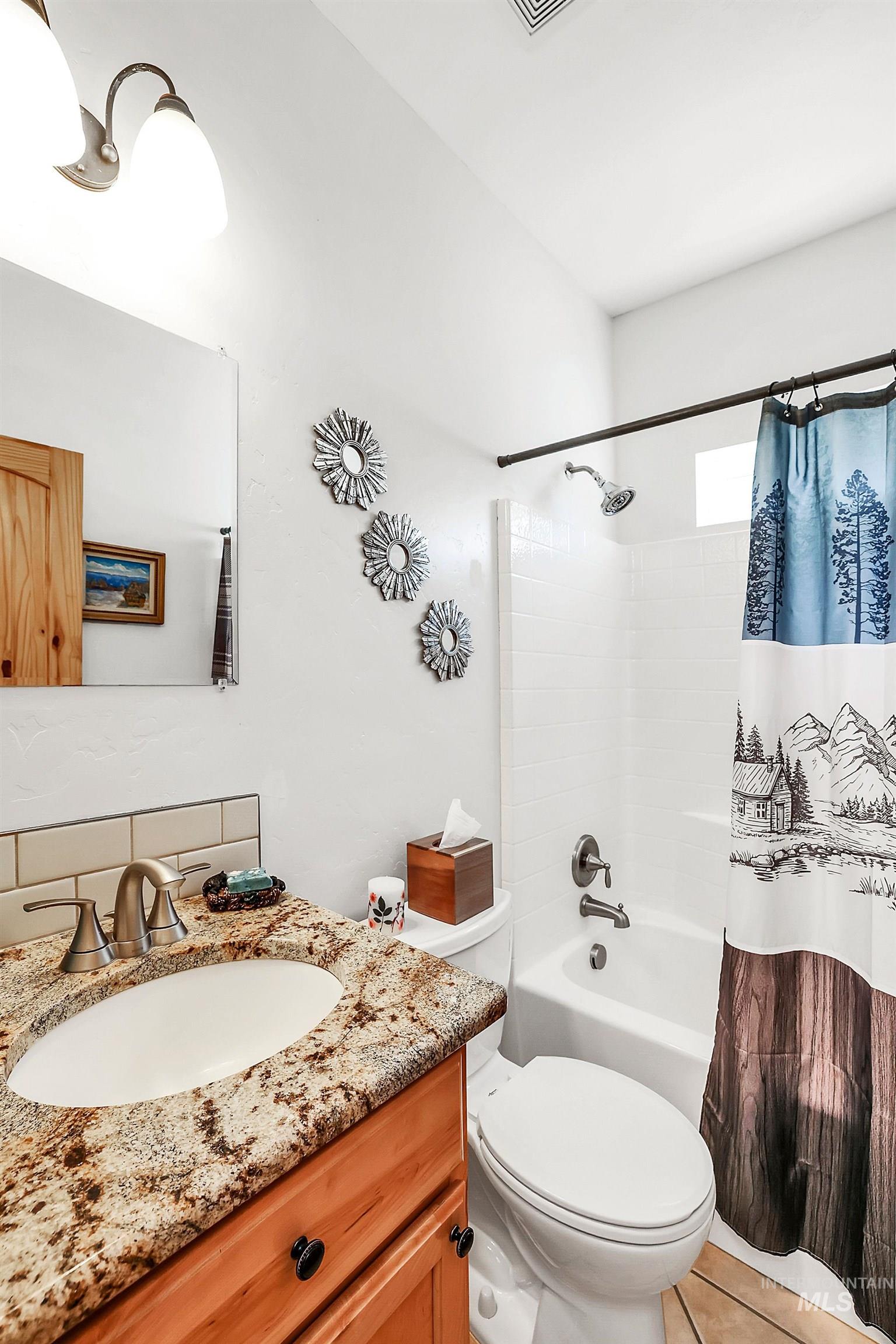 12954 Upland Road Donnelly, ID 83615 - Photo 23 of 41 Bathroom with vanity and shower / bathtub combination with curtain