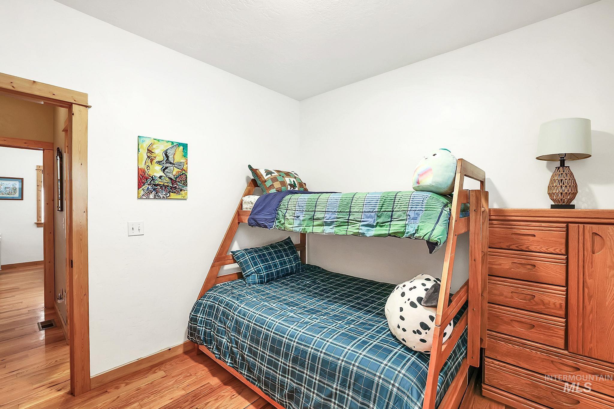 12954 Upland Road Donnelly, ID 83615 - Photo 26 of 41 Bedroom with light wood-style flooring and baseboards