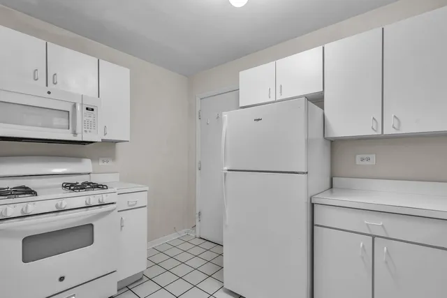 a white refrigerator freezer and a stove in a kitchen