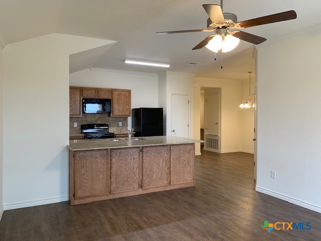 279 Olaf Drive Temple, TX 76504 - Photo 3 of 14 a view of a livingroom with a flat screen tv wooden floor and a ceiling fan