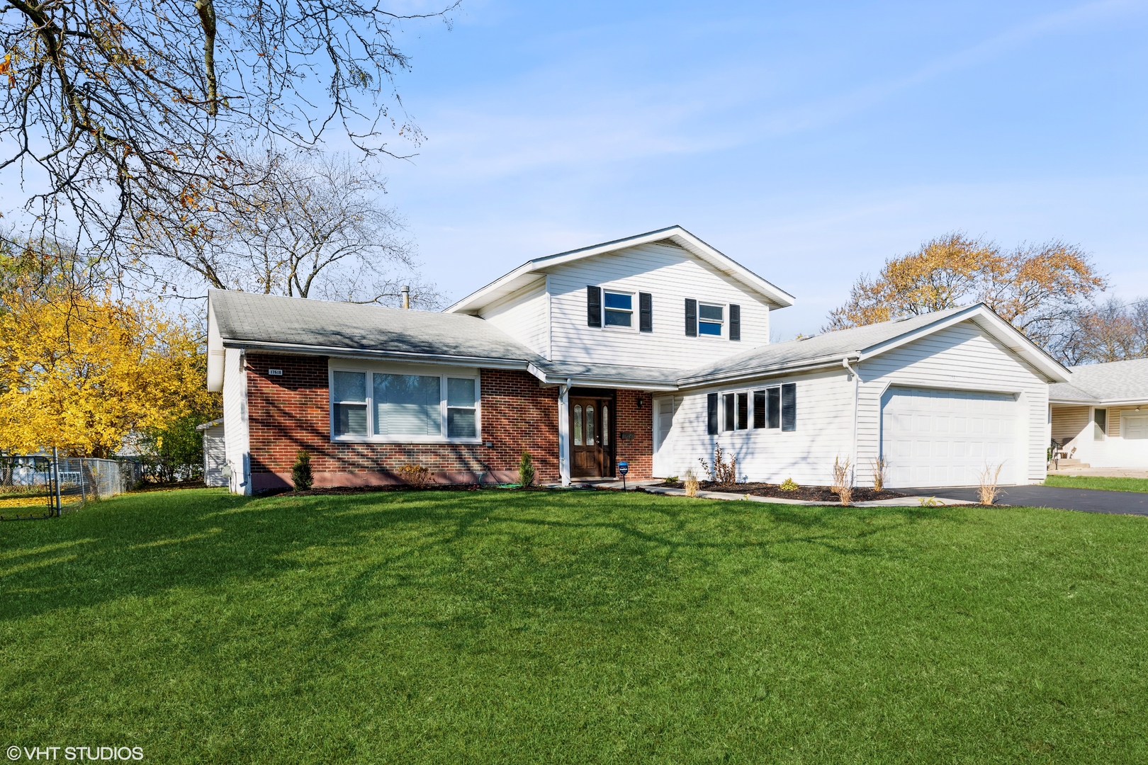 17618 Maple Avenue Country Club Hills, IL 60478 - Photo 1 of 14 a front view of a house with a yard and trees