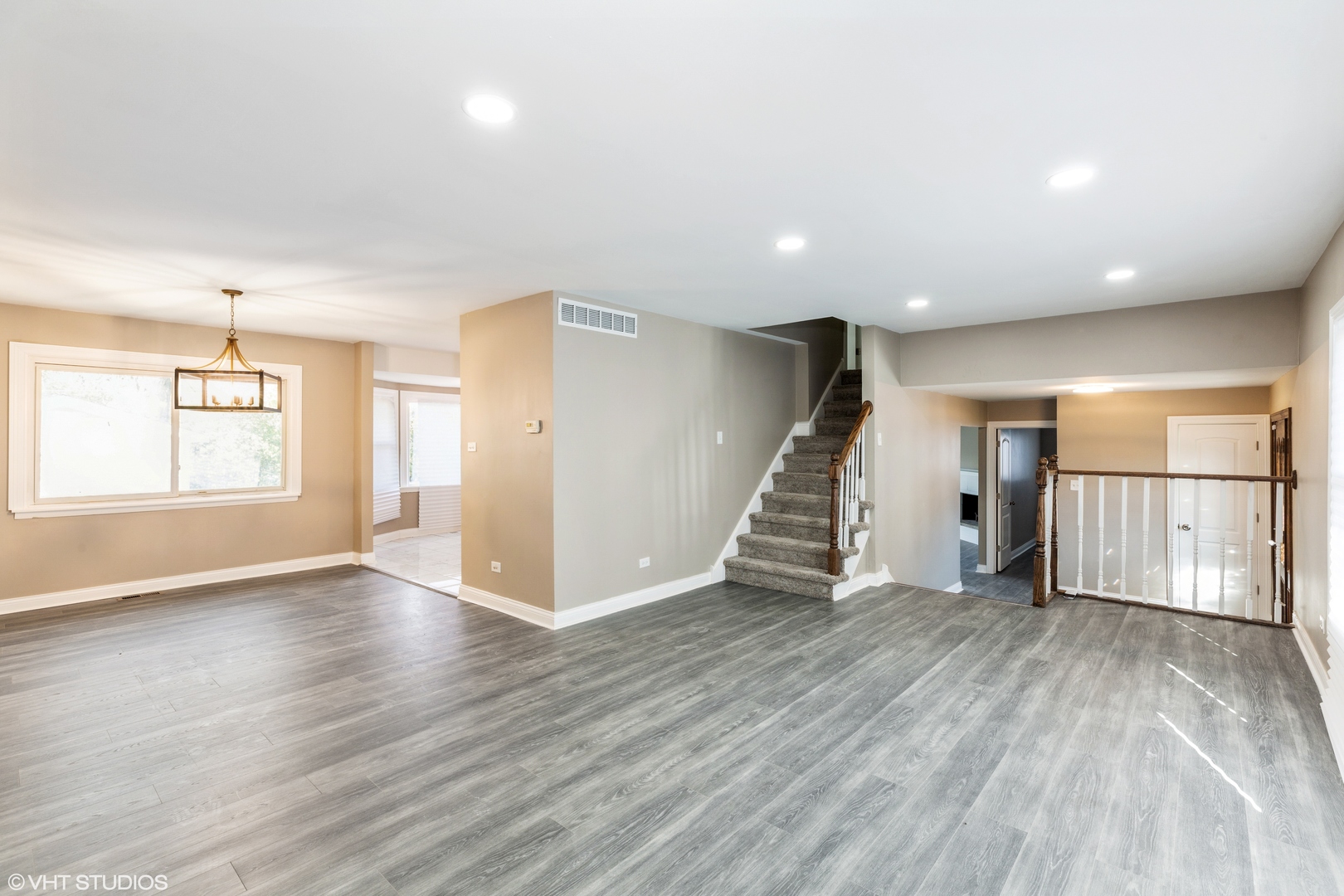 17618 Maple Avenue Country Club Hills, IL 60478 - Photo 3 of 14 an empty room with wooden floor staircase and windows