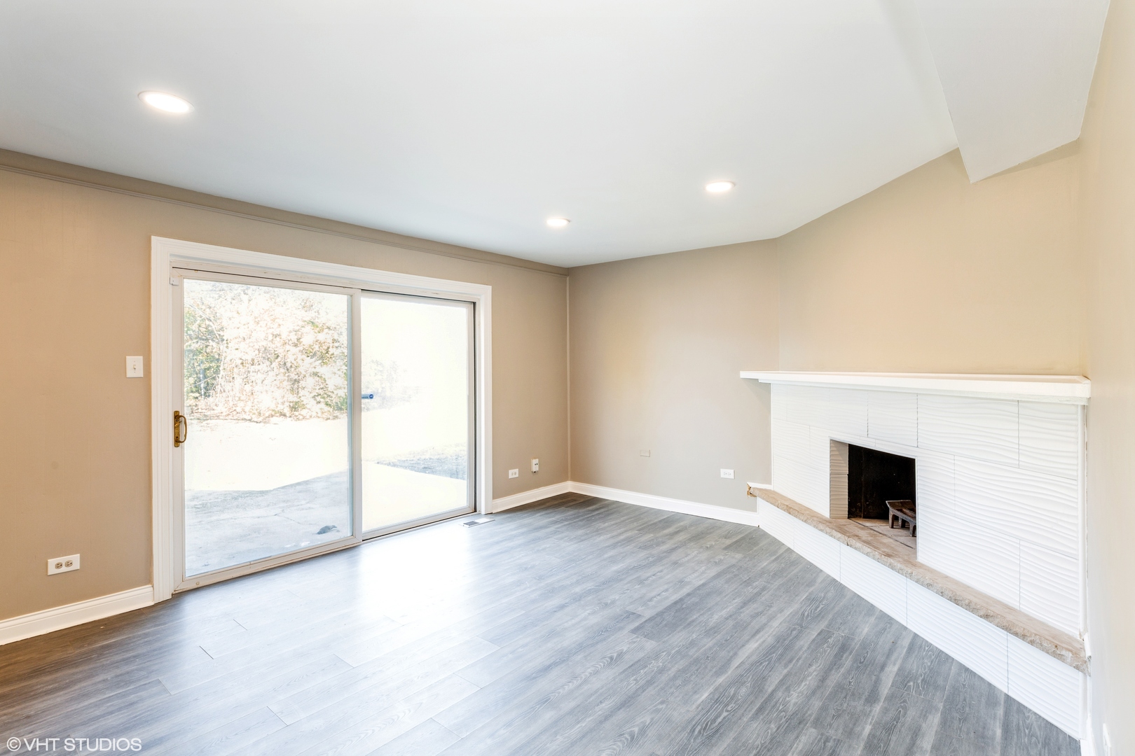17618 Maple Avenue Country Club Hills, IL 60478 - Photo 7 of 14 an empty room with wooden floor and fireplace