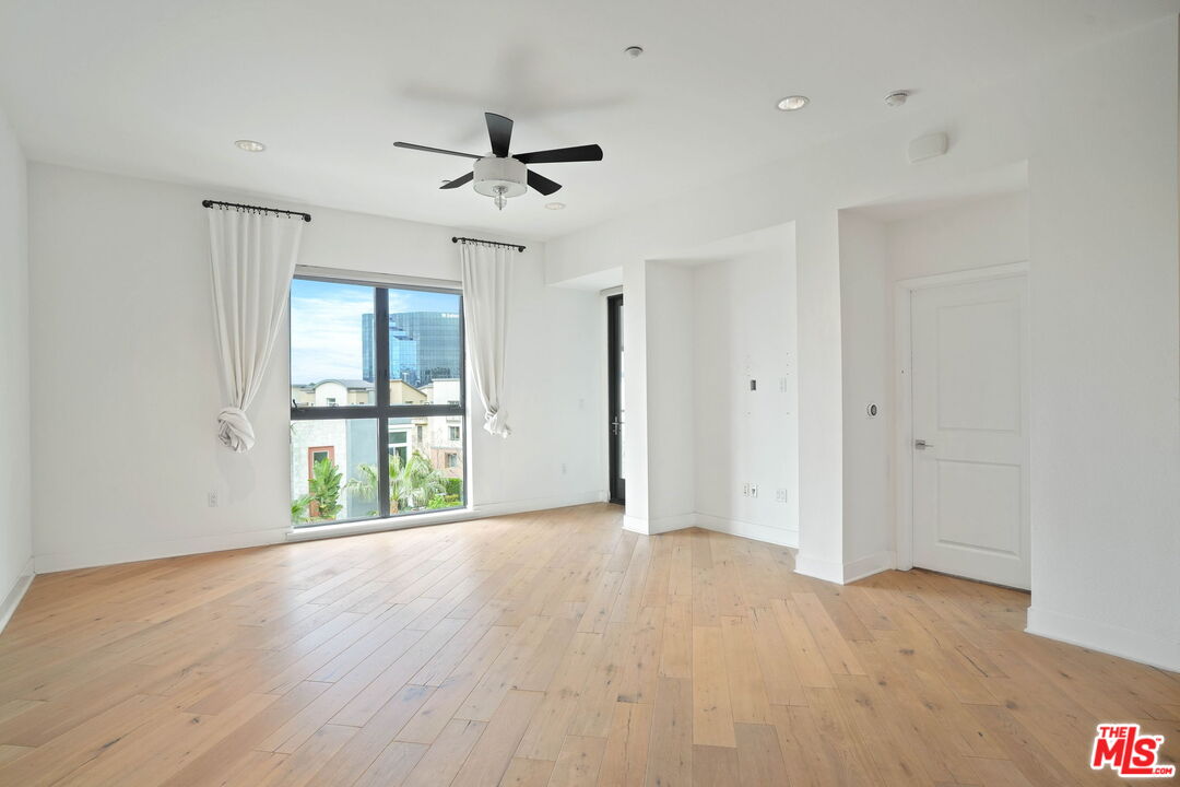 402 Rockefeller, Unit 406 Irvine, CA 92612 - Photo 11 of 33 a view of an empty room with a window and wooden floor