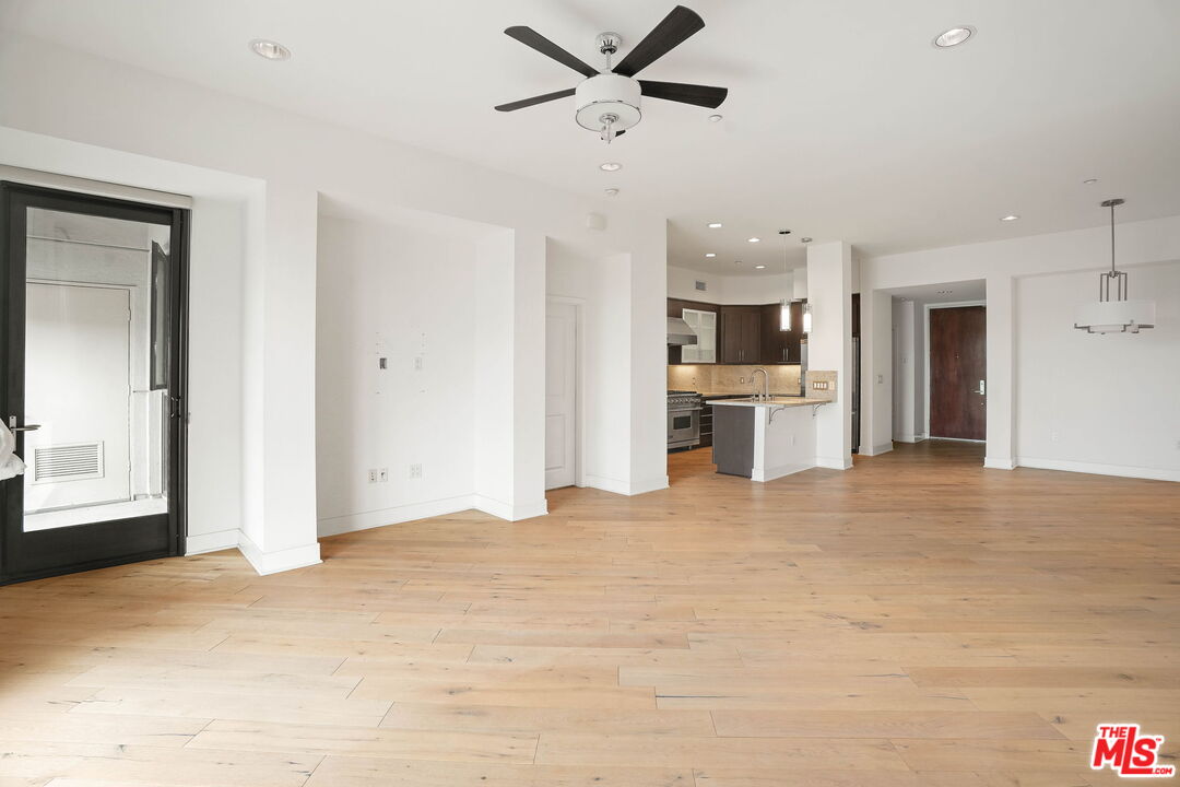 402 Rockefeller, Unit 406 Irvine, CA 92612 - Photo 13 of 33 a view of a kitchen with furniture and a ceiling fan