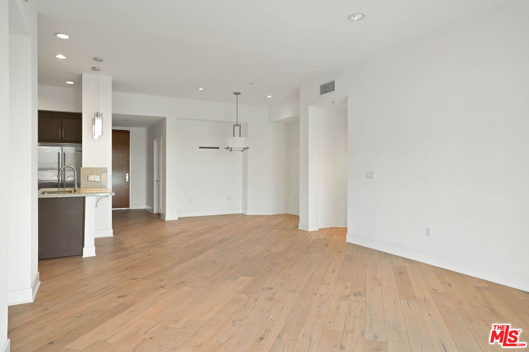 402 Rockefeller, Unit 406 Irvine, CA 92612 - Photo 14 of 33 a view of an empty room with a kitchen