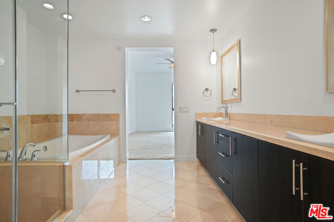 402 Rockefeller, Unit 406 Irvine, CA 92612 - Photo 20 of 33 a spacious bathroom with a double vanity sink a mirror and a bathtub