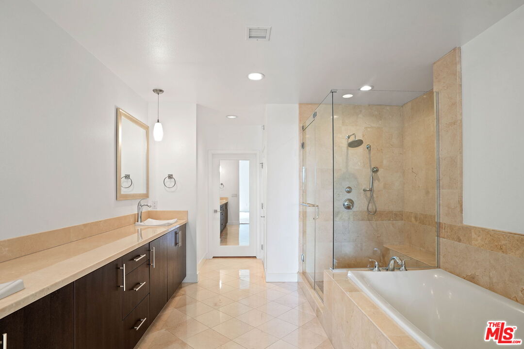 402 Rockefeller, Unit 406 Irvine, CA 92612 - Photo 21 of 33 a spacious bathroom with a shower tub double sink and mirror