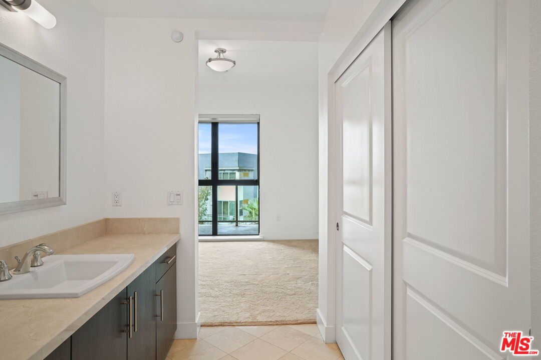 402 Rockefeller, Unit 406 Irvine, CA 92612 - Photo 23 of 33 a bathroom with a sink and a mirror