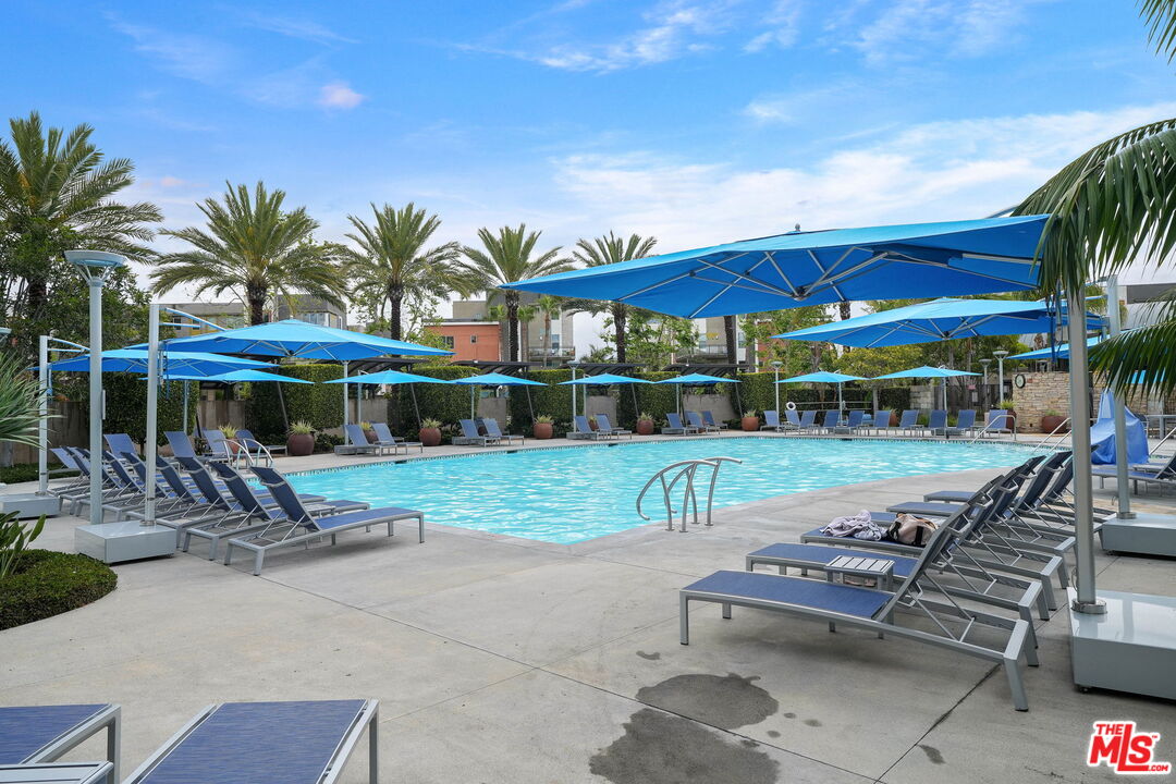 402 Rockefeller, Unit 406 Irvine, CA 92612 - Photo 29 of 33 a view of a table and chairs under an umbrella