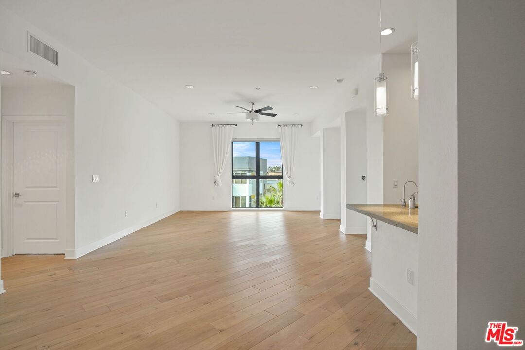 402 Rockefeller, Unit 406 Irvine, CA 92612 - Photo 4 of 33 wooden floor in an empty room with a window