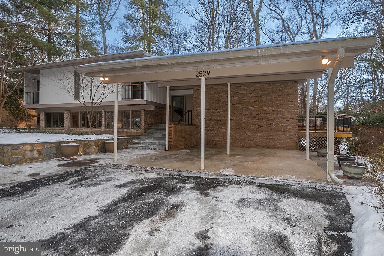 front view of a house with a large window and a yard