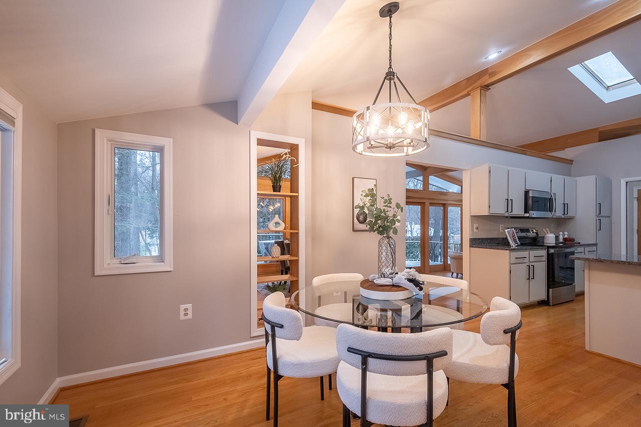 2529 Trophy Lane Reston, VA 20191 - Photo 11 of 69 a dining room with furniture a chandelier and wooden floor
