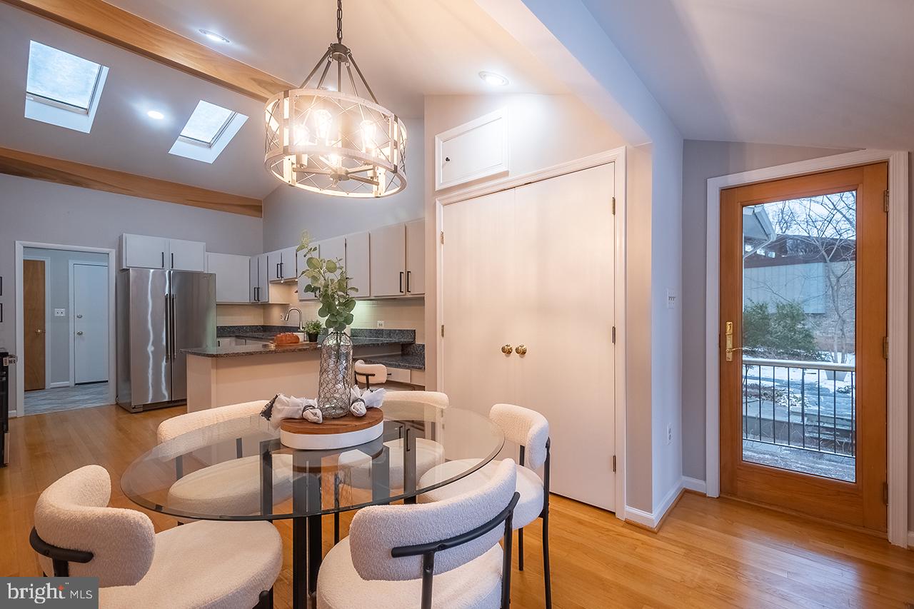 2529 Trophy Lane Reston, VA 20191 - Photo 12 of 69 a dining room with furniture a chandelier and wooden floor