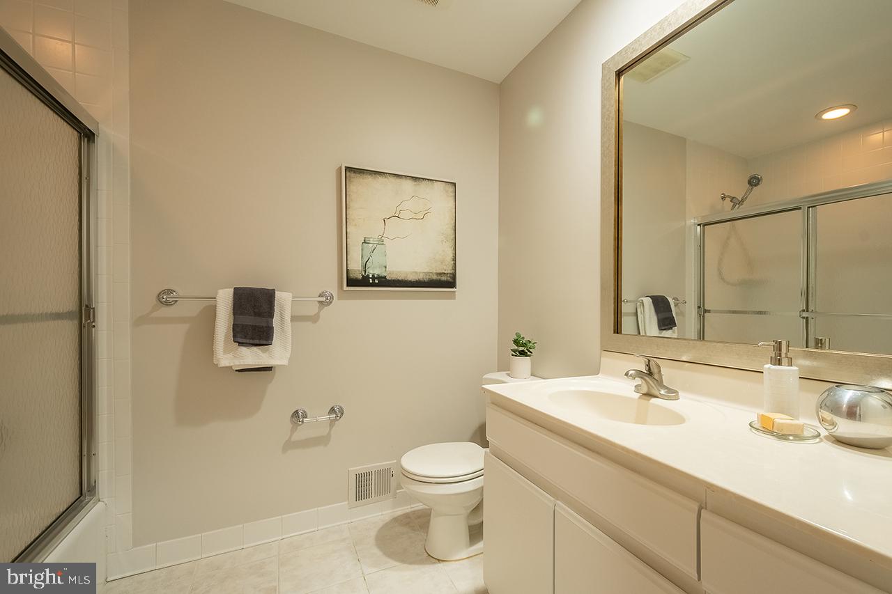 2529 Trophy Lane Reston, VA 20191 - Photo 36 of 69 a bathroom with a granite countertop sink toilet a large mirror and shower