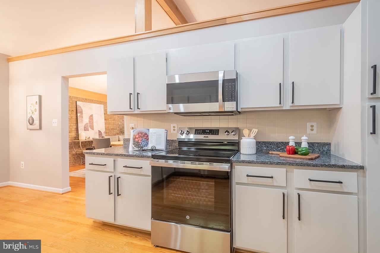 2529 Trophy Lane Reston, VA 20191 - Photo 9 of 69 a kitchen with granite countertop a sink stainless steel appliances and cabinets