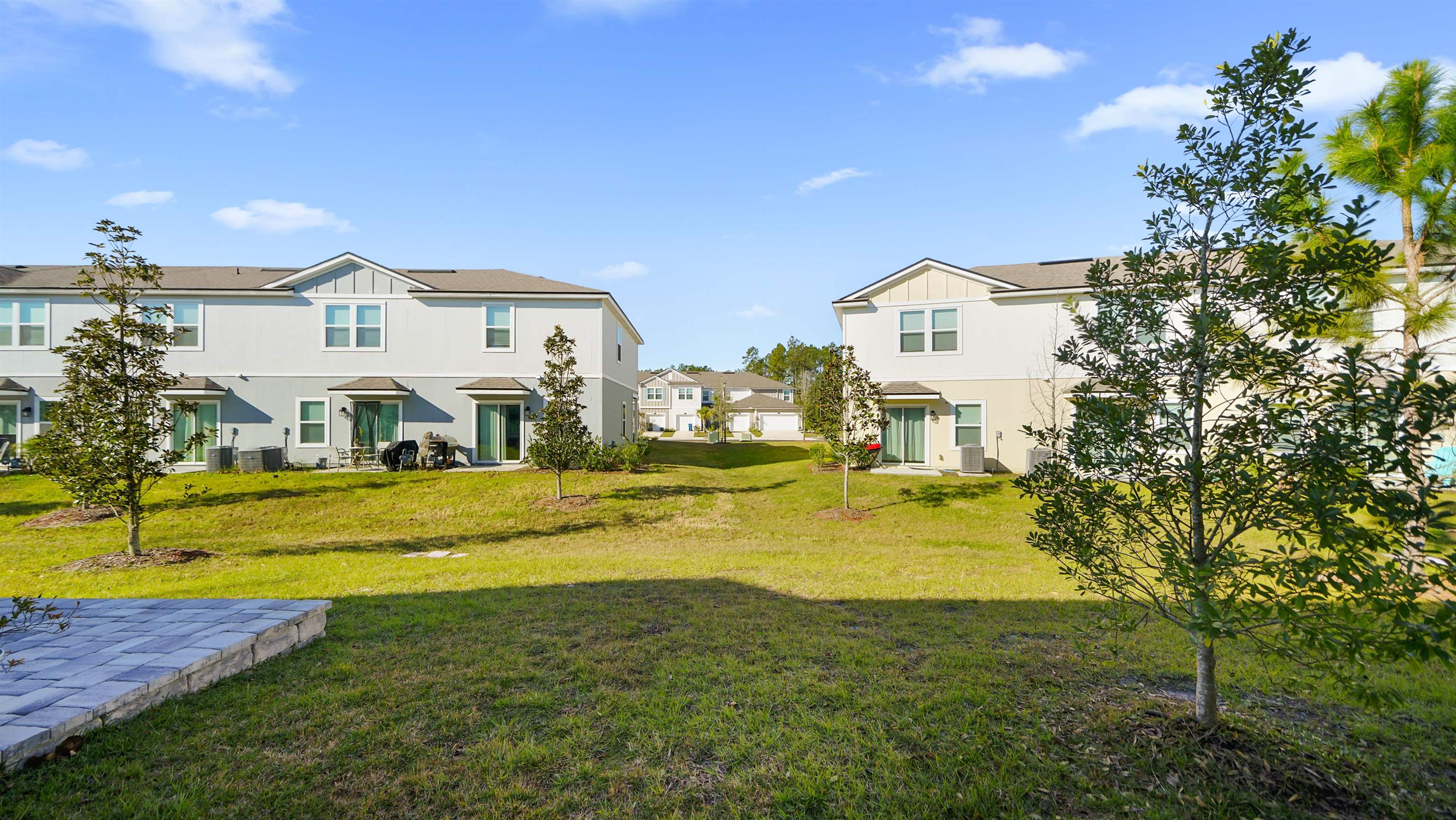87 Ember Street St. Augustine, FL 32092 - Photo 20 of 28 a view of a house with a big yard and large trees